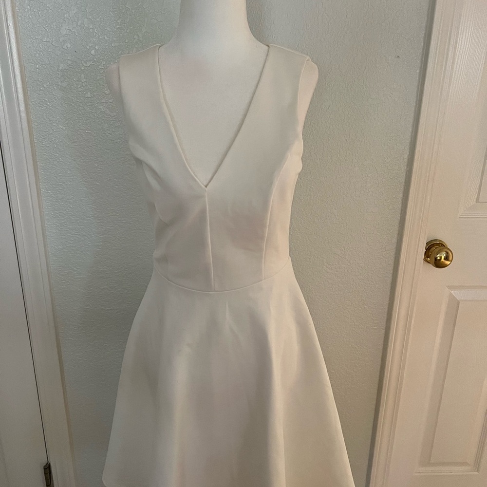 Lulu's White A-line Mini Dress with V-neck and Sleeveless Design